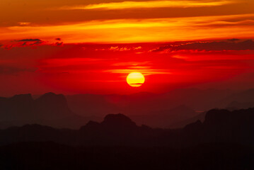 Scenic view dramatic beautiful sunset sky. Natural Sunset Sunrise on meadow silhouette shadow dark land. Vibrant dramatic sky on sunset, dawn, sunrise in Countryside. Landscape Colorful Sky At Sunset