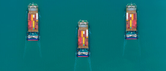 Aerial side view of cargo ship carrying container and running for export goods from cargo yard port...