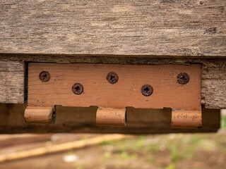 door hinges with bolt details that have rusted with age
