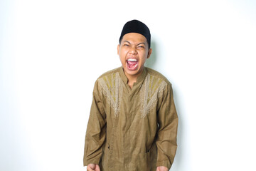Fototapeta premium angry asian muslim male screaming with grabbing hand looking at camera isolated on white background