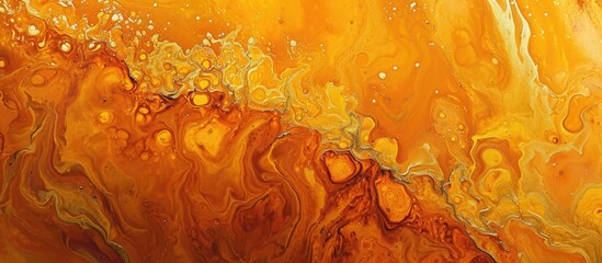 Spilled orange paint creates a vibrant abstract artwork with a golden texture, suitable for various...