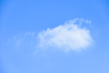 beautiful blue sky and white fluffy single cloud with sunrise in the morning, natural background