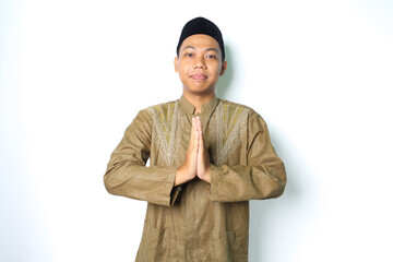 peaceful asian muslim man give greeting wearing koko clothes in eid al fitr celebration isolated on...