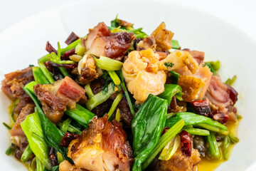 A plate of stir-fried bacon chicken