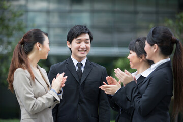 Business team applauds each other.