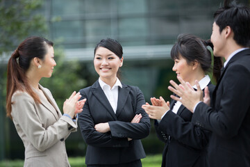 Business team applauds each other.