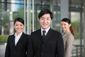 Happy Asian businessman with his team.