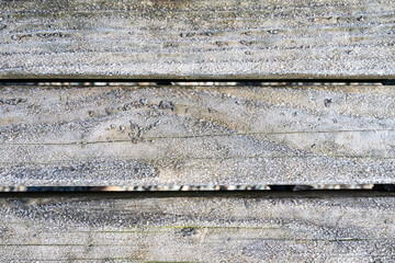 Frost covered wooden bench boards, as a winter background
