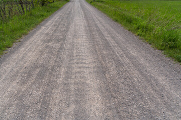 Naklejka premium Gravel road in the landscape 