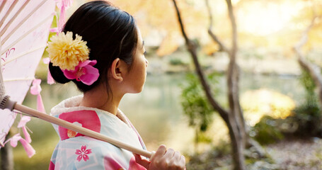 Nature, traditional and Japanese woman in park for thinking, fresh air and relax with umbrella...