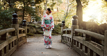 Bridge, traditional and Japanese woman in park for walking, fresh air and relax outdoors. Travel,...