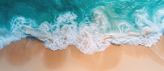 Fototapeta na wymiar Ocean water viewed from above with clear foam. Sand visible beneath. Beach, summer, vacation, coastline, seashore, travel, tourism, wallpaper.