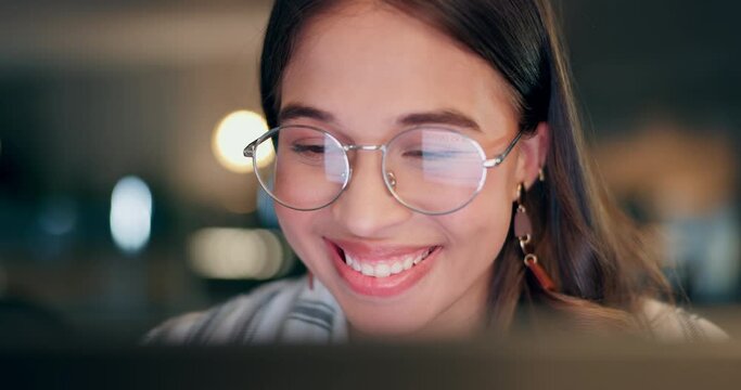 Business woman, reading with glasses and night research on computer for project, copywriting or editing report. Young editor or happy writer with screen reflection for analysis, news and editing