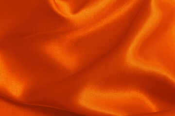 Fototapeta premium Orange fabric cloth texture for background and design art work, beautiful crumpled pattern of silk or linen.