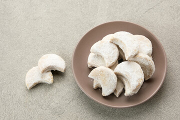 Kue Putri Salju or Snow White Cookies with crescent shaped. Made from flour, sugar and butter coated with powdered sugar. 
