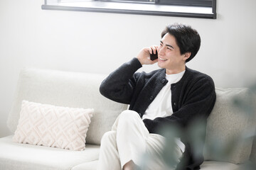 Handsome Asian man talking on his phone