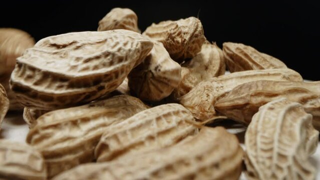 Macro closeup isolate footage of a lot raw peanut or groundnut with peel and unpeel for ingredient