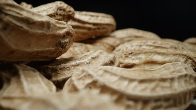 Macro closeup isolate footage of a lot raw peanut or groundnut with peel and unpeel for ingredient