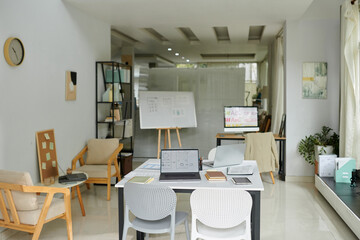 Office of UI and UX designers with whiteboard, couple desks and chill area