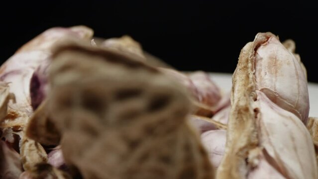 Macro closeup isolate footage of a lot raw peanut or groundnut with peel and unpeel for ingredient