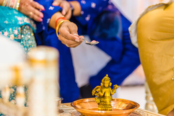 Fototapeta na wymiar Indian Hindu wedding ceremony Ganesh pooja ritual close up