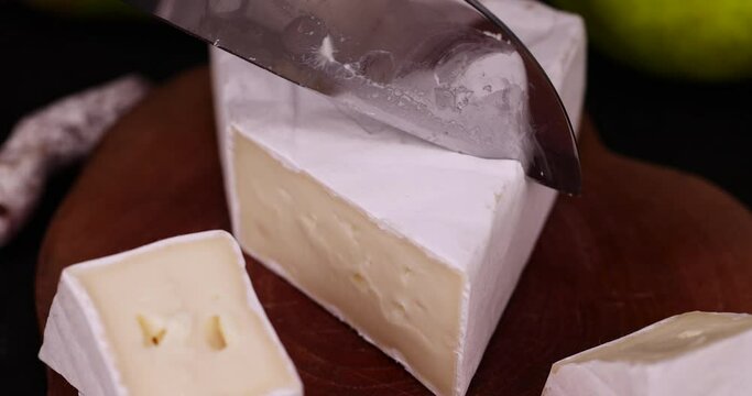 cheese with white mold cut into chunks , preparation of cheese with mold for use in cooking