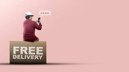 People in hat sit on the large packet for delivery with free delivery text while using mobile phones