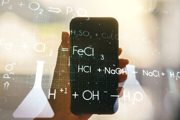 Creative chemistry hologram and hand with cellphone on background, pharmaceutical research concept....
