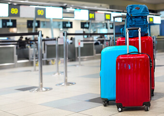 Stack of travelers luggage in airport terminal