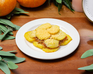 Potatoes with minced meat and cheese on a plate.