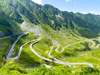 Fototapeta na wymiar Unusual winding road high in the mountains on a summer day