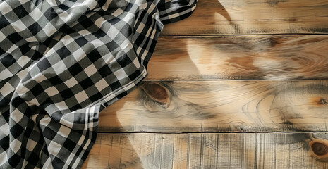 Top view of black checkered tablecloth on blank empty wooden table background banner, food concept.