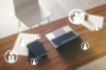 Double exposure of social network icons concept and modern desktop with laptop on background. Marketing and promotion concept