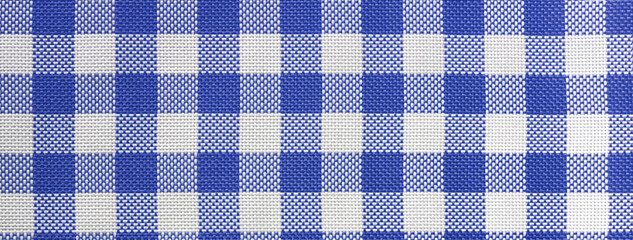 Checkered tablecloth for the table in navy blue and white cells. Background texture of denim...