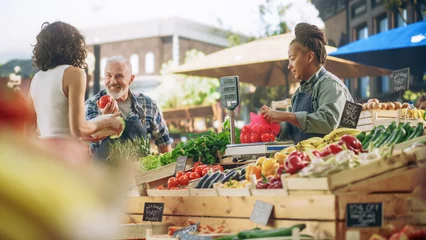 Keuken spatwand met foto Latin Female Customer Buying Sustainable Organic Tomatoes and Napa Cabbage From a Multiethnic Farmers Couple. Successful Street Vendors Managing a Small Business Farm Stall at an Outdoors Market © Gorodenkoff