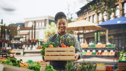 Portrait of a Black Female Working at a Farmers Market Stall with Fresh Organic Agricultural...