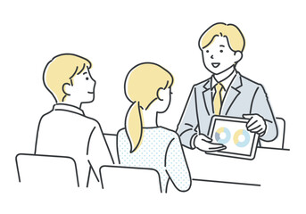 若いカップルに案内をする営業担当者