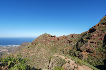 Panoramic View of Rugged Anaga Mountains, Tenerife - Clear Blue Sky, Lush Greenery, and Ocean Horizon