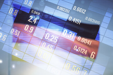 Double exposure of abstract virtual statistics data hologram on German flag and blue sky...