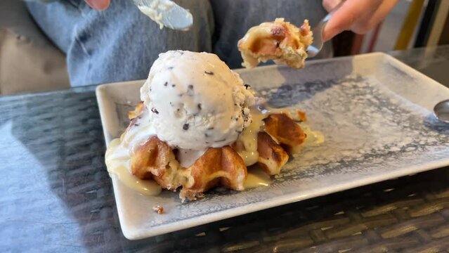 cutting and eating white chocolate and stracciatella waffle