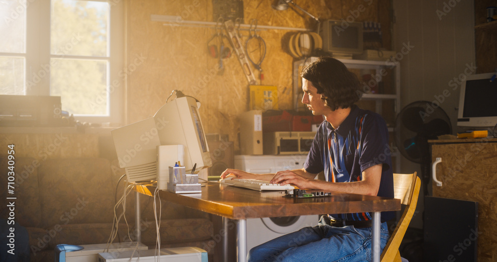 Poster Caucasian Male Software Engineer Programming On Old Desktop Computer In Retro Garage With Random Appliances. Man Starting an Innovative Fintech Startup Company In Nineties. Nostalgia Concept.