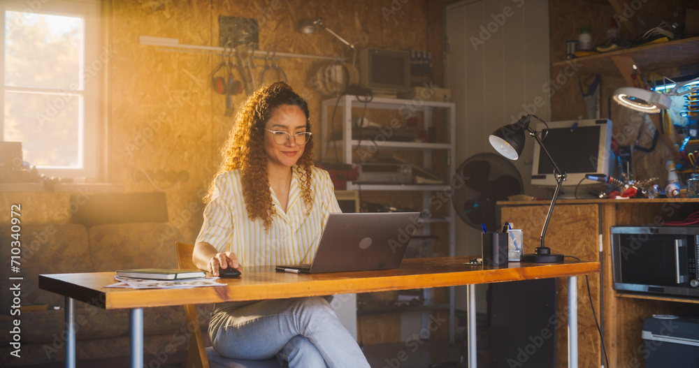 Aufkleber hispanic female programmer writing code on laptop computer in garage at home. woman working on innov