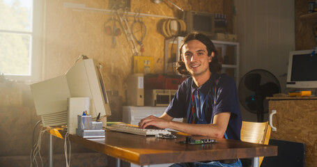 Caucasian Male Software Engineer Programming On Old Desktop Computer In Retro Garage, Looking At...