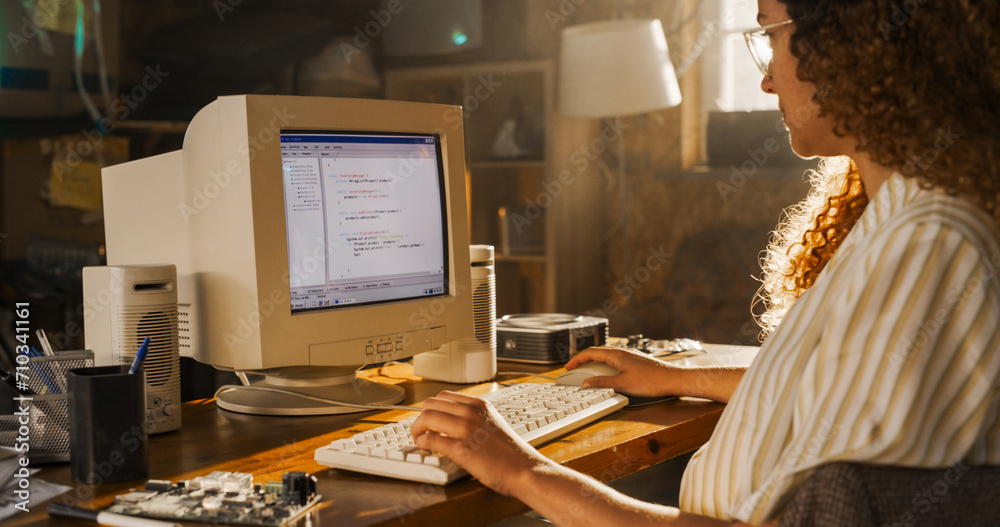 Aufkleber side view of hispanic female engineering student writing academic thesis on old desktop computer in 