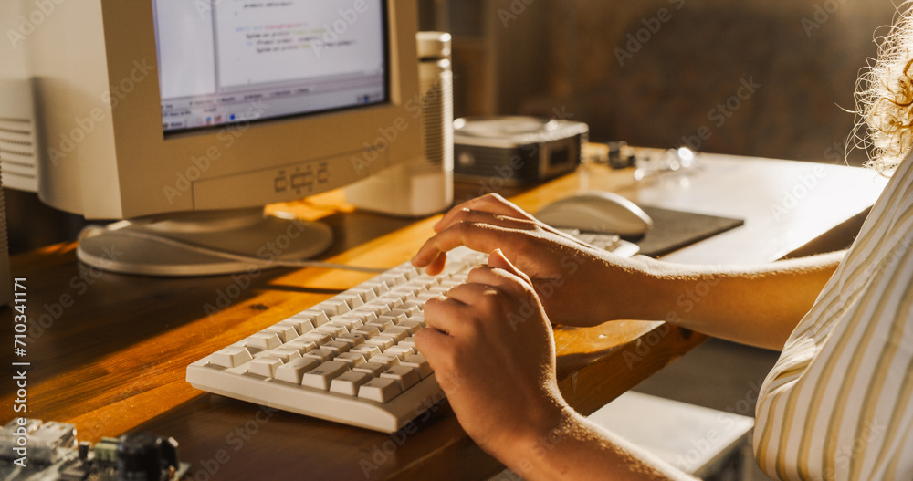 Poster Side View Of Hispanic Female Software Engineer Programming on Old Desktop Computer In Retro Garage. Focused Woman Starting Tech Startup Company In Nineties. Coding Innovative Online Service At Home.