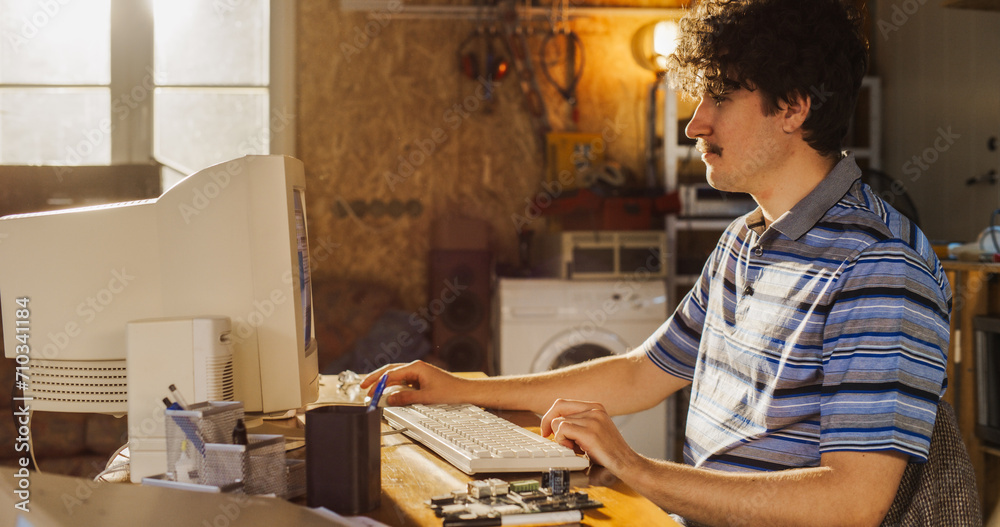 Leinwandbilder Caucasian Male Hardware Engineer Programming On Old Desktop Computer In Retro Garage. Experienced Software Developer Writing Code For New Innovative Operating System In Nineties.