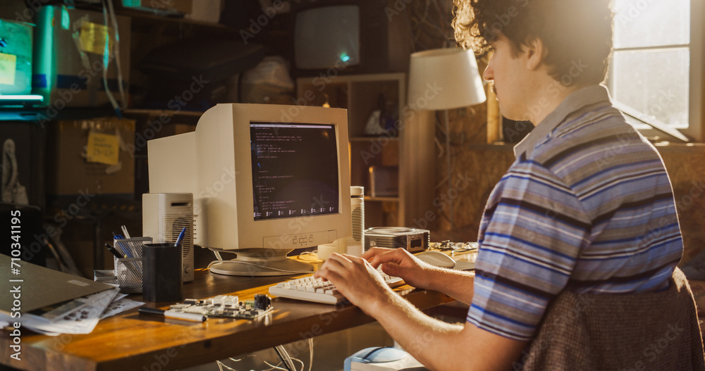 Poster Caucasian Male Computer Engineer Programming On Old Desktop Computer In Retro Garage. Experienced Software Developer Writing Code For New Innovative Portable Device Startup In Nostalgic Nineties.