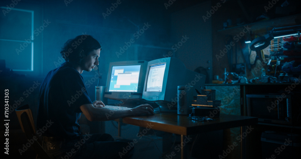 Poster Caucasian Male Programmer Using Old Desktop Computer With Two Monitors In Retro Garage Late At Night. White Hat Hacker Searching For Software Vulnerabilities, Coding Cyber Security System In Nineties.