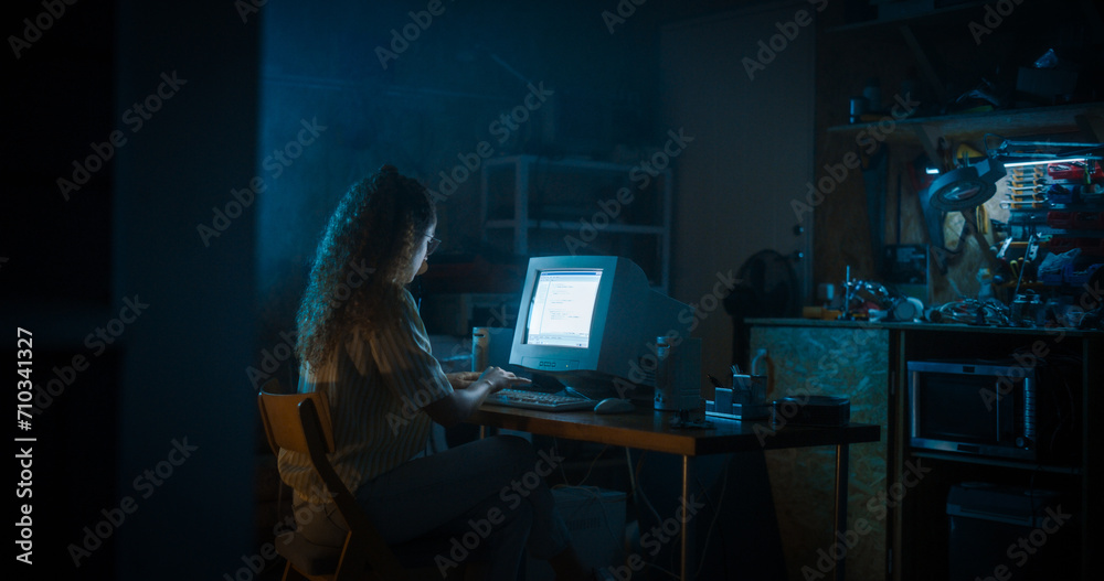 Poster Hispanic Female Programmer Using Old Desktop Computer In Retro Garage Late At Night. White Hat Hacker Searching For Software Vulnerabilities, Coding Cyber Security System, Protecting Data In Nineties.