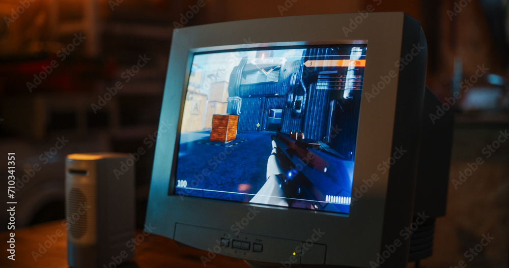 Leinwandbilder close up of old desktop computer with 3d first-person shooter video game in retro garage late at nig